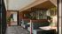 Modern lounge area with stylish booth seating, warm lighting, and vibrant wall art, offering a cozy space for relaxation or work.