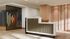 Elegant apartment lobby featuring a modern reception desk, artistic wall divider, and warm wooden accents.
