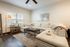 Inviting living room with a cozy cream sectional sofa, elegant wooden flooring, and modern decor accents, perfect for relaxation and entertainment.