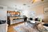 Inviting living area with cozy seating, a modern kitchen, and stylish d&eacute;cor, perfect for relaxation and entertaining.