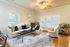 Chic and cozy living room with elegant furniture, ambient lighting, and a stylish drinks trolley, perfect for entertaining.