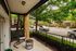 Charming urban balcony with cozy swing chair, perfect for relaxing and enjoying the vibrant neighborhood view.