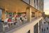 Modern outdoor patio at Intro, featuring stylish wooden accents and a vibrant social setting, perfect for relaxing and dining.