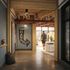 Inviting modern hallway with stylish decor, featuring a cozy hangout spot and warm ambient lighting.