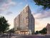 Modern high-rise apartment building with sleek architecture, large windows, and vibrant city surroundings at sunset.