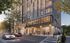 Modern apartment building with sleek design, large windows, and a bustling street view.