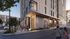 Modern urban residential building with vibrant street art, stylish facade, and welcoming entrance, situated on a lively city street.