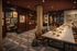 Modern co-working space with warm lighting and dedicated study areas, featuring elegant decor and framed artwork.