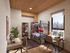 Modern bedroom with bunk beds, twin desks, large window offering city views, and stylish decor.