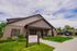 Inviting leasing office exterior with brick facade and manicured landscaping at modern residential community.