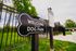Inviting dog park entrance with lush green surroundings and welcoming signage.