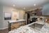 Modern kitchen with sleek dark cabinetry, stainless steel appliances, and elegant granite countertops accompanied by stylish decor accents.