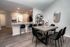 Inviting open-concept dining and kitchen area with modern decor and elegant finishes, perfect for entertaining.