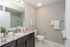 Modern bathroom with sleek granite countertop, stylish fixtures, and elegant marble tile flooring.