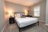 Inviting bedroom with a cozy modern bed, soft lighting, and elegant decor for ultimate comfort and relaxation.