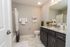 Modern bathroom with elegant marble countertop, sleek cabinetry, and stylish decor accents.