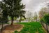 Charming park area with lush greenery, vibrant trees, and cozy benches offering a serene retreat.