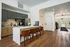 Modern apartment kitchen with sleek cabinetry, stainless steel appliances, and an inviting breakfast bar with elegant seating.