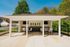 Charming outdoor pavilion with modern seating and natural surroundings.