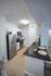 Modern kitchen with sleek stainless steel appliances, elegant black granite countertops, and bright white cabinetry, offering a chic and functional space for culinary creativity.