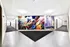 Vibrant apartment hallway featuring artistic wall mural with colorful urban and musical themes, adding a unique and lively atmosphere.