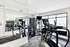 Bright, modern fitness center with state-of-the-art exercise equipment and large windows offering natural light.
