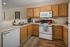 Charming kitchen with modern appliances, wooden cabinets, and cozy decor.
