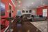 Contemporary living room with elegant hardwood floors, vibrant red accent wall, cozy gray sofa, and artistic wall decor.