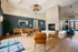 Elegant apartment lobby with modern leather chairs, a cozy fireplace, and chic decor, offering a warm and inviting atmosphere.