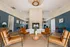 Modern, inviting lounge area with stylish leather chairs, a central table, and an elegant fireplace accentuated by contemporary decor.