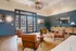 Luxurious lobby featuring elegant leather chairs, stylish wooden furniture, and sophisticated decor with warm natural lighting.