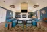 Elegant communal living space with modern blue sofas, stylish decor, and a cozy fireplace, perfect for relaxation and social gatherings.