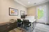 Bright and modern home office with sleek desks, vibrant wall art, and a French door for abundant natural light.