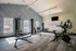 Bright and modern fitness center equipped with state-of-the-art exercise machines and stylish geometric wall design.