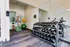 Modern fitness room featuring a variety of free weights, exercise balls, and state-of-the-art equipment, perfect for a complete workout.
