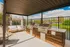 Inviting outdoor patio area featuring a state-of-the-art barbecue grill and cozy seating, perfect for entertaining with scenic views.