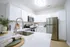 Modern kitchen with sleek white cabinetry, stainless steel appliances, and elegant countertops, perfect for gourmet cooking.