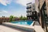 Modern apartment with a sparkling rooftop pool and stylish outdoor lounge, perfect for relaxation and entertainment.