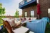 Chic and inviting apartment patio with cozy seating, lush greenery views, and modern design elements.