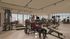 Modern fitness center with panoramic city views, featuring state-of-the-art gym equipment and a welcoming atmosphere.