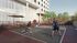 Contemporary apartment building featuring an outdoor recreational area with active pickleball players on a stylish court, set against a backdrop of lush greenery and modern architecture.