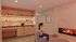 Cozy lounge area featuring modern shelves with towels and toiletries, warm fireplace, comfortable seating, and ambient lighting.
