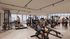 Modern gym with panoramic city views, featuring state-of-the-art equipment and vibrant social atmosphere.