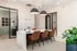 Elegant office space at Greenway Vista featuring a modern design with a sleek table, stylish leather chairs, and chic pendant lighting.