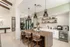 Elegant communal space with modern kitchen island, stylish pendant lighting, and sleek cabinetry. Perfect for entertaining and relaxation.
