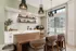 Modern kitchen with elegant open shelving, stylish pendant lighting, and a large wooden island, perfect for entertaining.