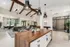 Elegant modern lobby featuring high ceilings with wooden beams, stylish pendant lighting, and a spacious seating area with lush greenery.
