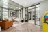 Modern and inviting living space featuring a plush white sectional sofa, stylish decor, and an arcade game machine, perfect for relaxation and entertainment.