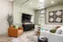Contemporary living room featuring a cozy sectional sofa, stylish armchair, modern entertainment setup, and unique dice artwork on the wall.