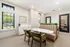 Chic dining area with plush seating, elegant table, and natural light, perfect for gatherings.